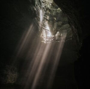 light streams into a cave from above