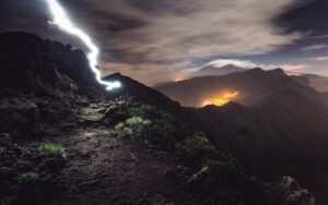 lightning strike on top of a mountain at night