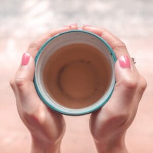 Hands hold a mug of tea