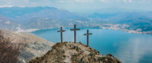 three crosses on a hill overlooking a bay